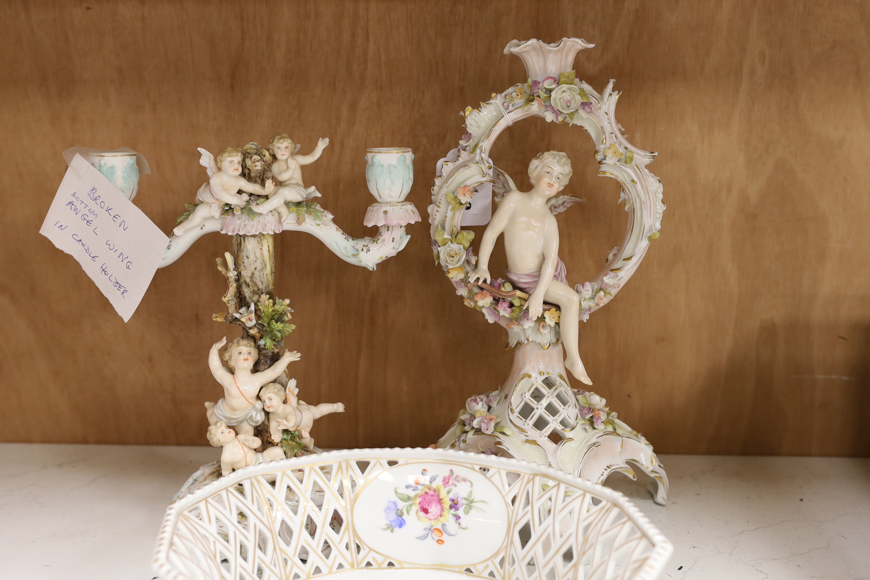A Volkstedt porcelain candelabrum decorated with cherubs, a candlestick and an octagonal basket